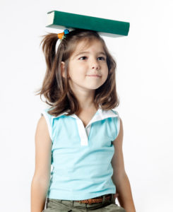 girl balancing a book on her head